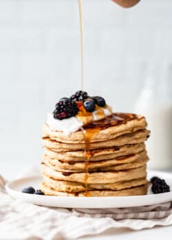 maple syrup being poured onto cottage cheese pancakes