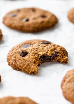 an almond flour chocolate chip cookie with a bite taken from it
