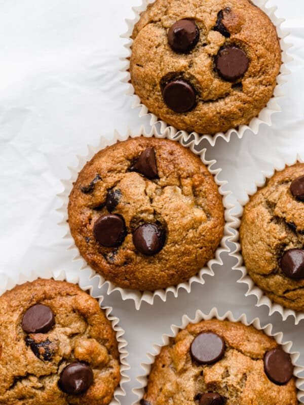 banana oat flour muffins with chocolate chips on parchment paper
