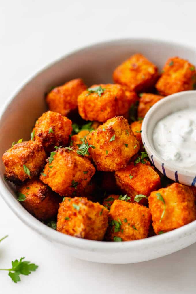 buffalo tofu in a bowl with parsley on top