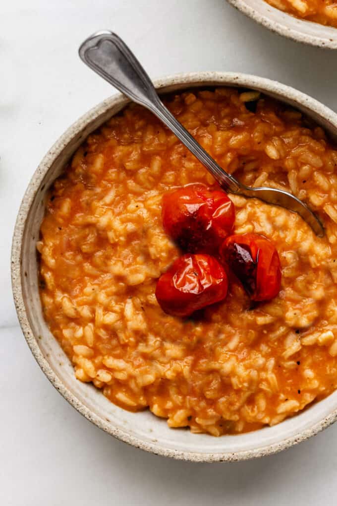 a bowl of tomato risotto topped with roasted tomatoes