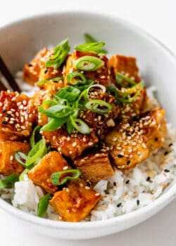 honey garlic tofu topped with scallions and sesame seeds