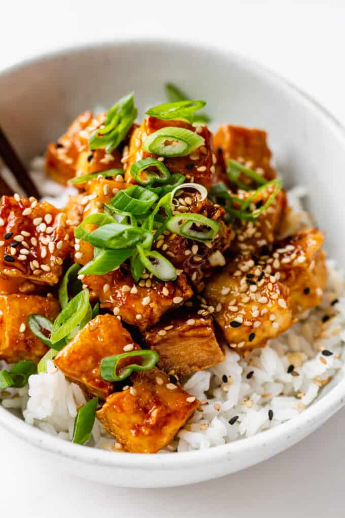 honey garlic tofu topped with scallions and sesame seeds