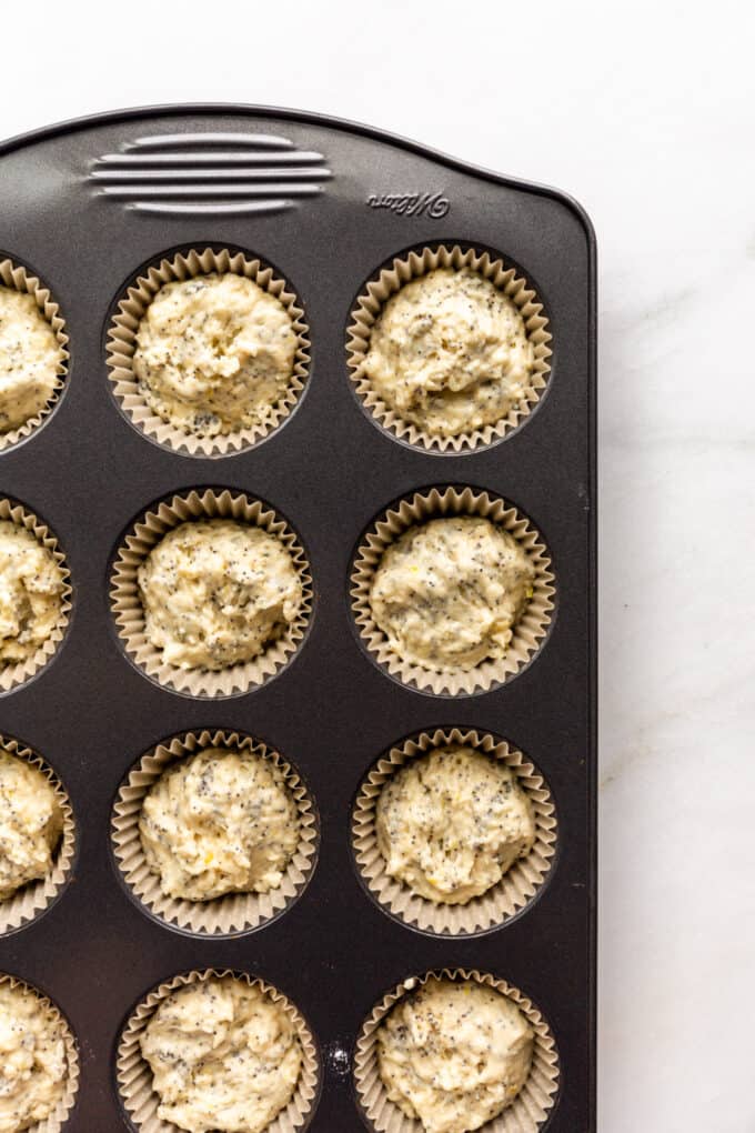 unbaked lemon poppyseed muffins in a muffins pan