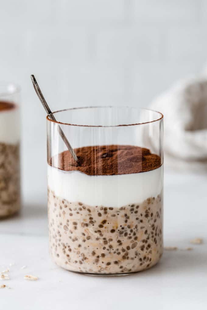 tiramisu overnight oats in a cup with a spoon in it