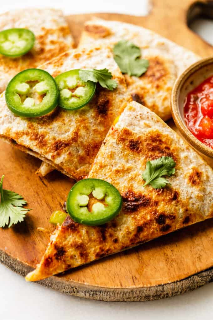 veggie quesadillas topped with sliced jalapeno and cilantro