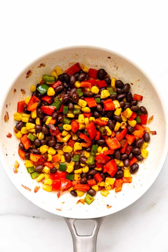 mixed vegetables and black beans in a pan