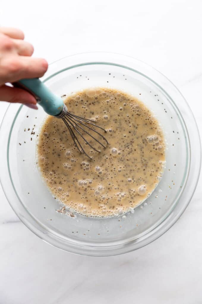 coffee chia pudding being whisked in a mixing bowl