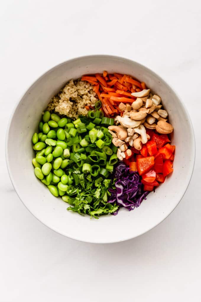 edamame beans, quinoa, cashews and vegetables in a salad bowl