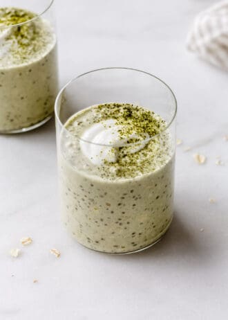 two cups of matcha overnight oats topped with yogurt