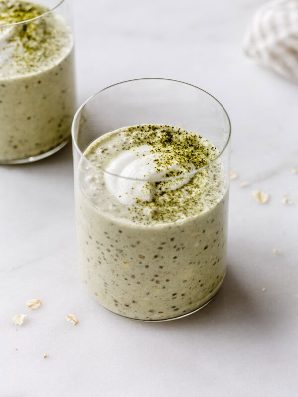 two cups of matcha overnight oats topped with yogurt