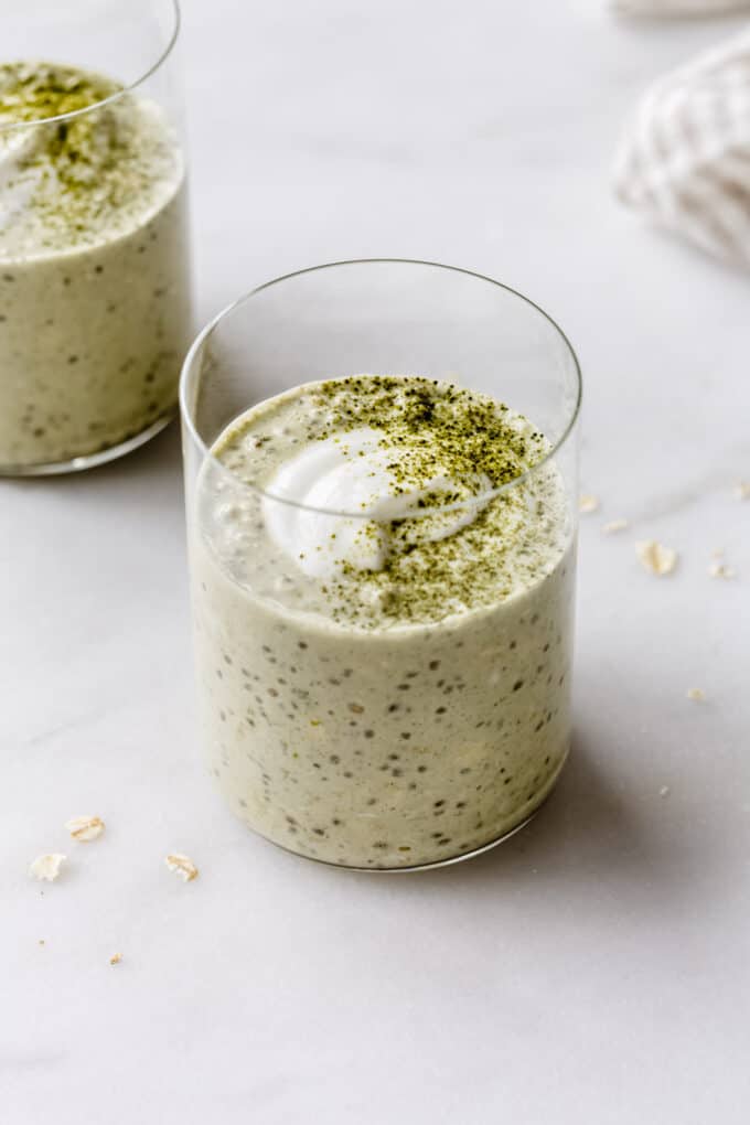 two cups of matcha overnight oats topped with yogurt