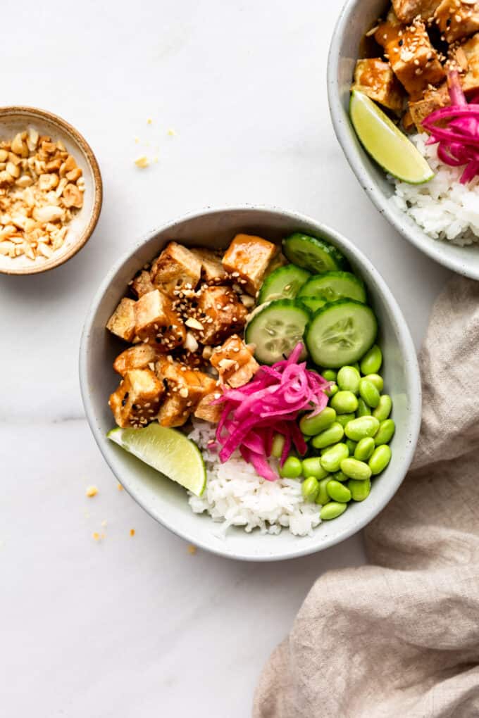 tofu, cucumber, edamame and pickled onions in a bowl with rice