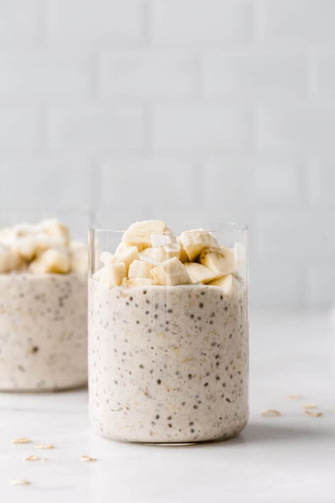 two cups of banana overnight oats topped with banana