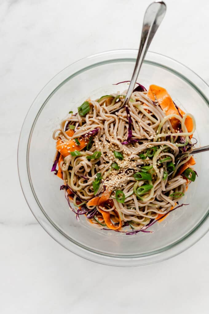 soba noodle salad mixed together in a mixing bowl