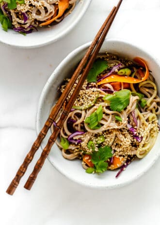 cold soba noodle salad in a bowl with wood chopsticks