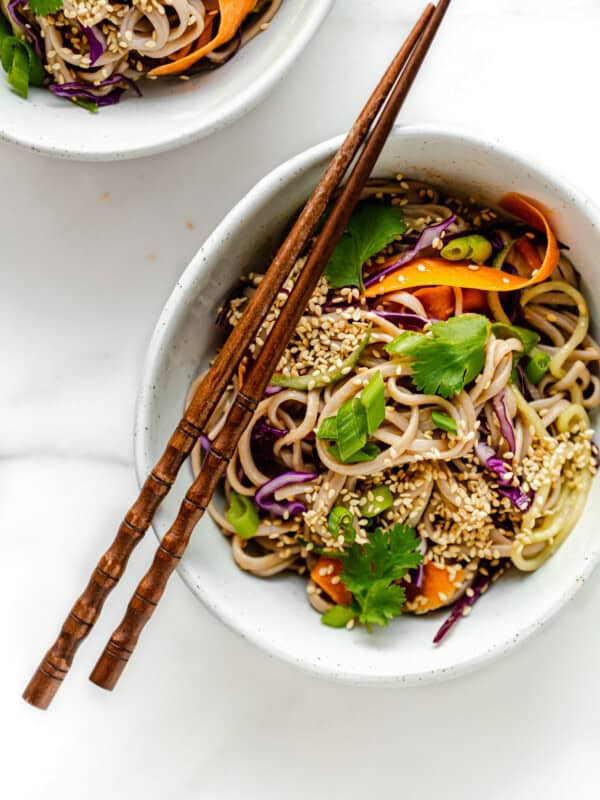 cold soba noodle salad in a bowl with wood chopsticks