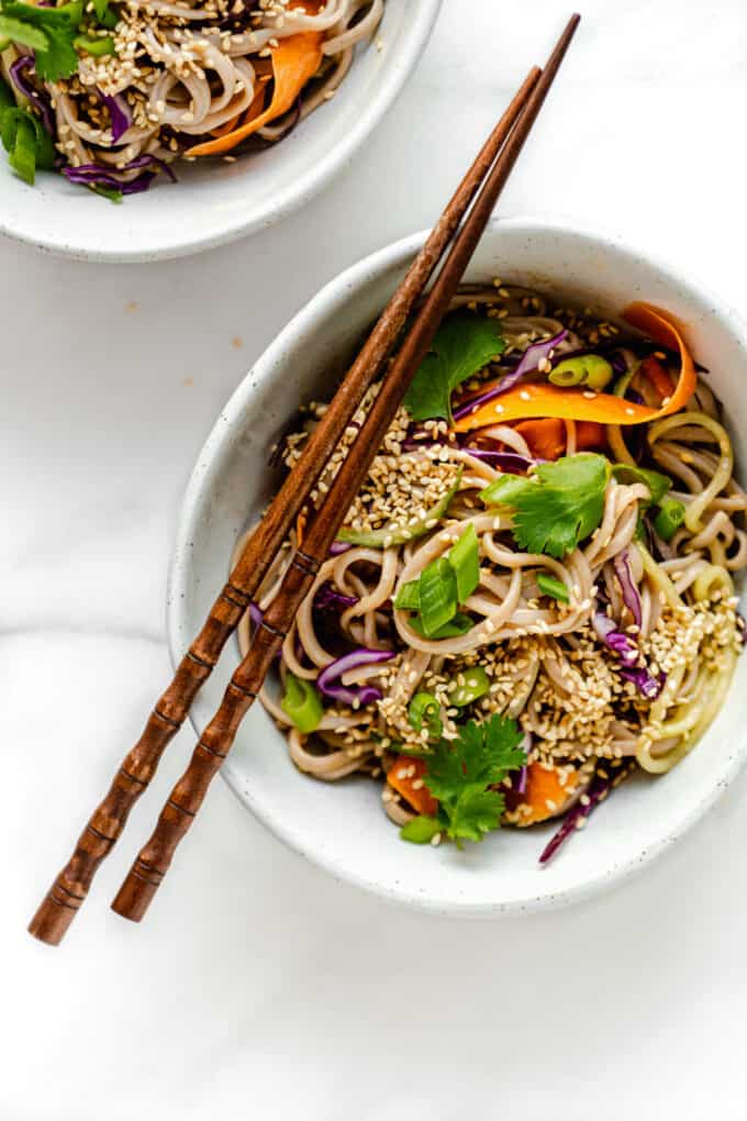 cold soba noodle salad in a bowl with wood chopsticks