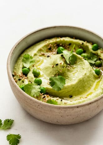Green pea hummus in a ceramic bowl