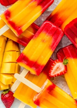 strawberry mango popsicles stacked on ice