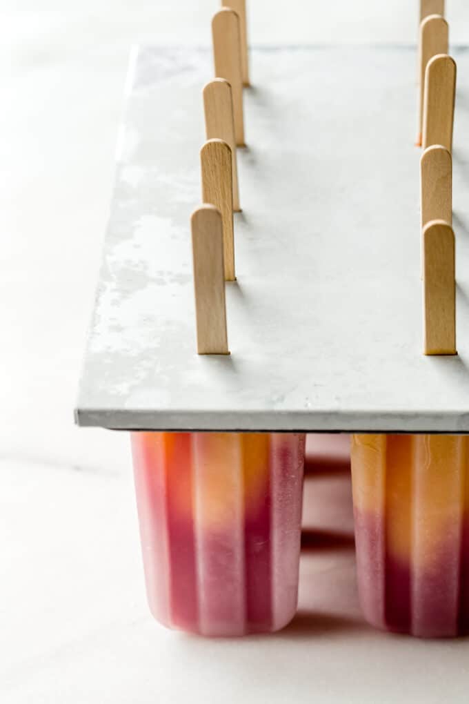 strawberry mango popsicles in a popsicle mold