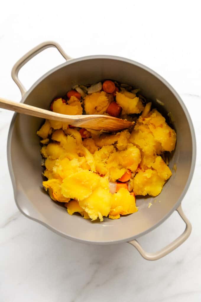 onions, garlic, carrots and roasted squash in a large pot