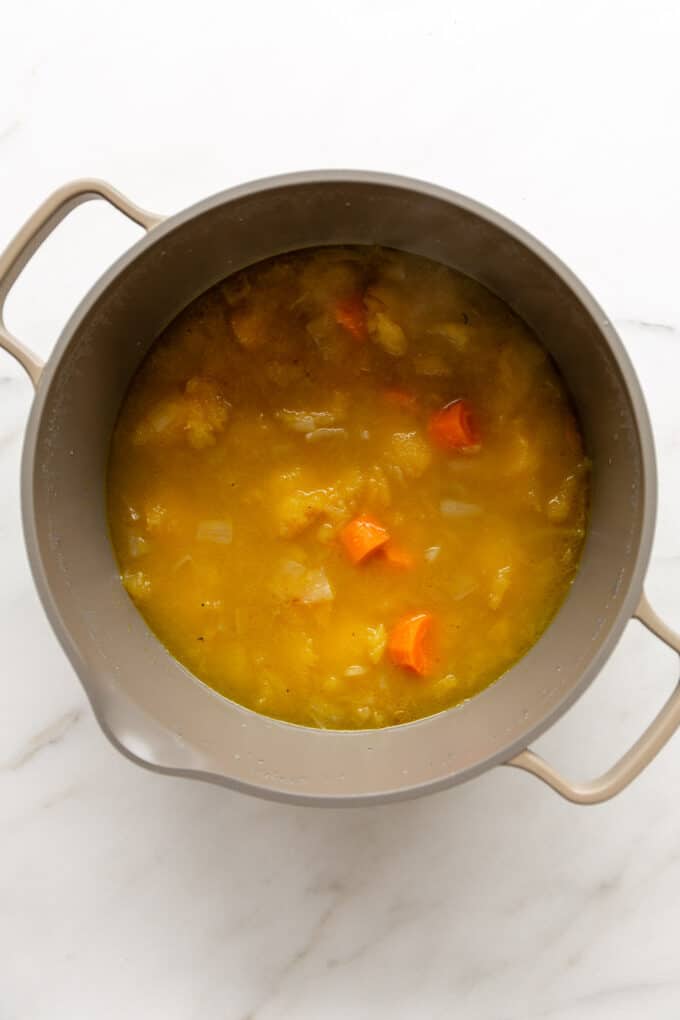 acorn squash soup simmering in a large pot
