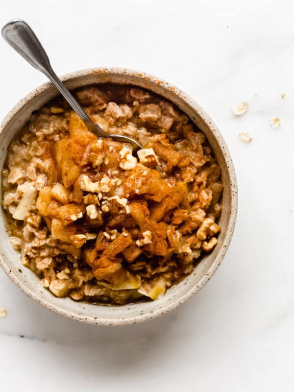 cinnamon apple pie oatmeal with a spoon in a bowl