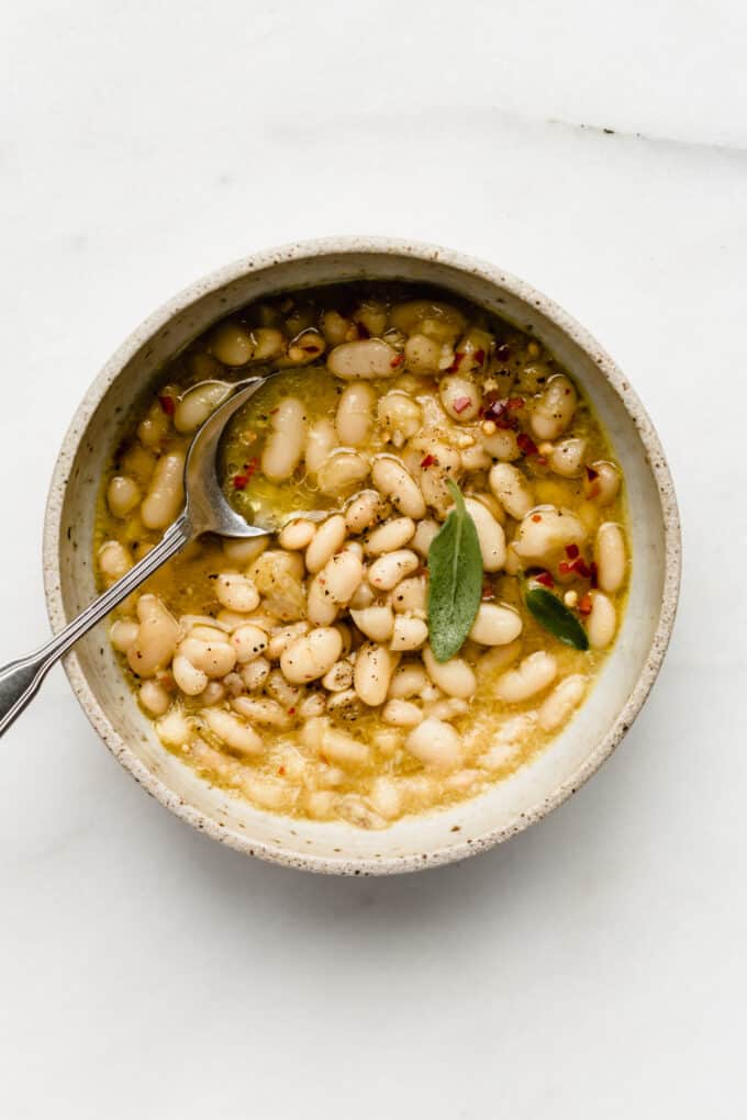 a bowl of cannelini beans in broth