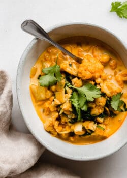 cauliflower curry in a bowl with a spoon