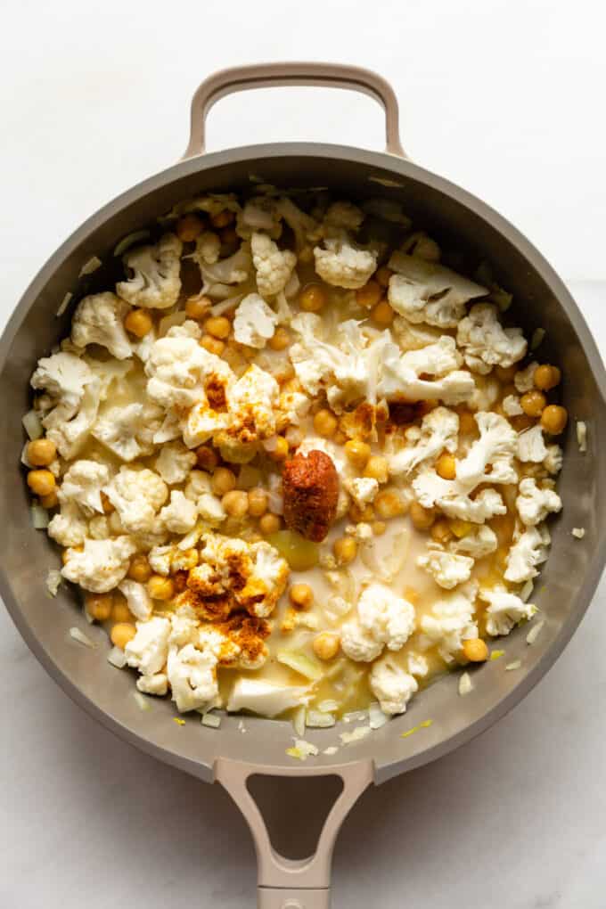 cauliflower, chickpeas, curry paste and coconut milk in a pan
