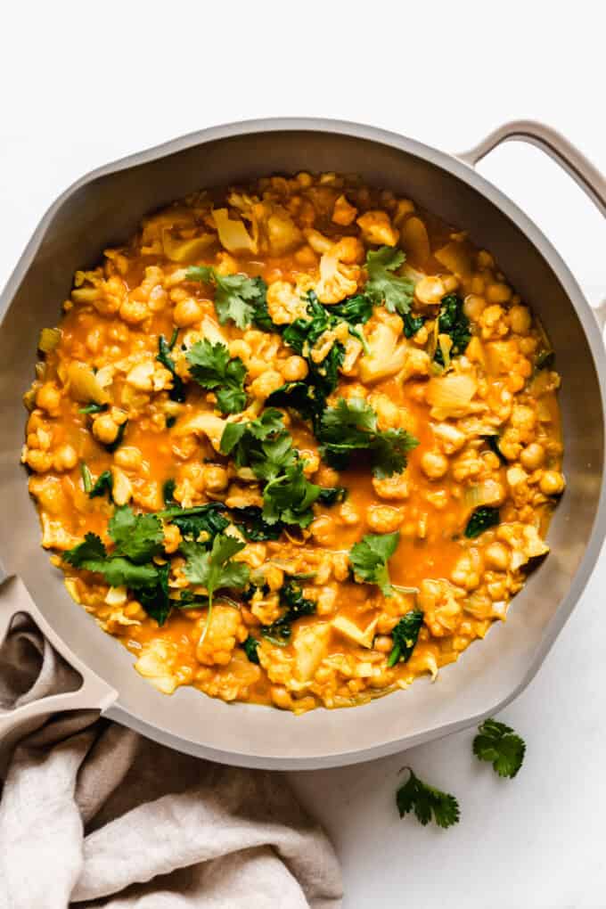cauliflower curry topped with cilantro in a pan