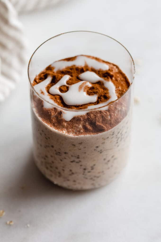 cinnamon roll overnight oats topped with cinnamon and icing