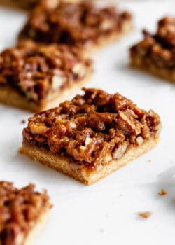 pecan pie bars cut up on a marble board