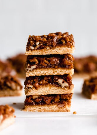 a stack of four pecan pie bars on a marble board