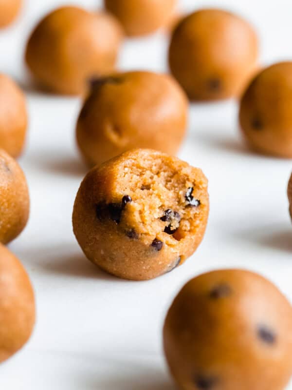 a pumpkin protein ball with a bite taken out of it