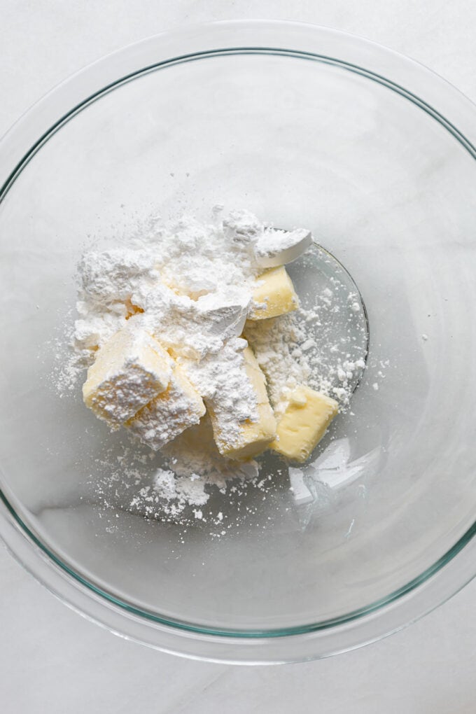 butter and powdered sugar in a clear mixing bowl