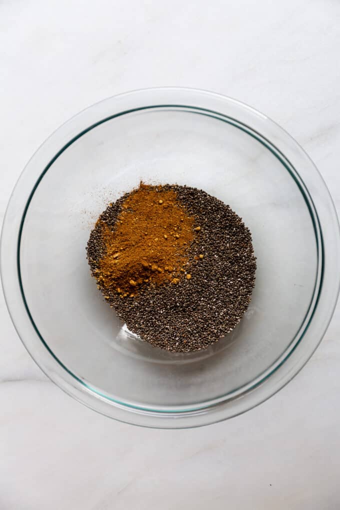 chia seeds and gingerbread spices in a clear mixing bowl