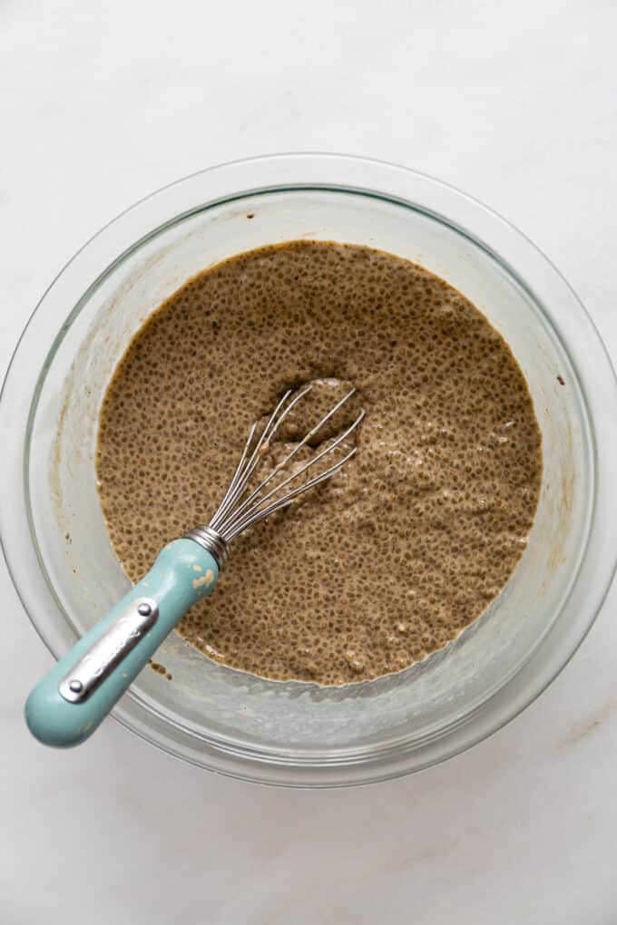 gingerbread chia pudding in a mixing bowl with a whisk