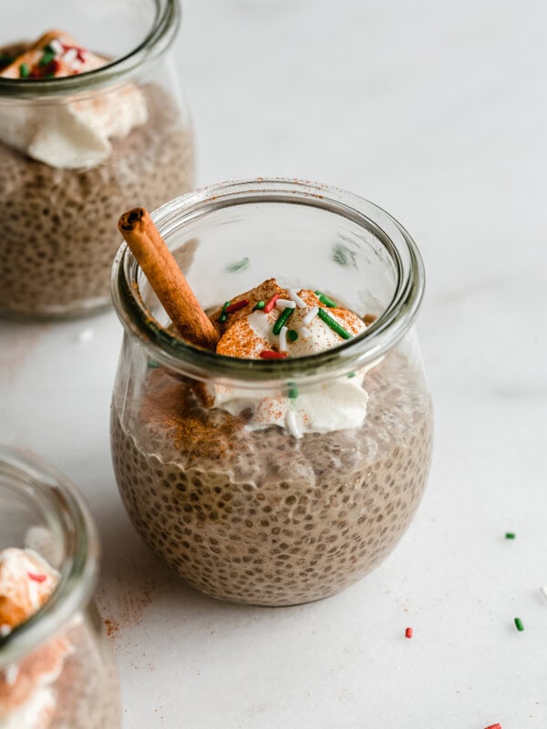 a jar of gingerbread chia pudding with red and green sprinkles