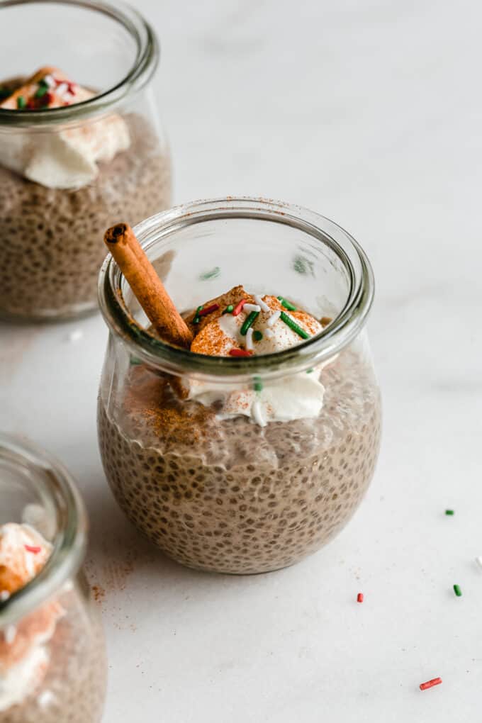 a jar of gingerbread chia pudding with red and green sprinkles