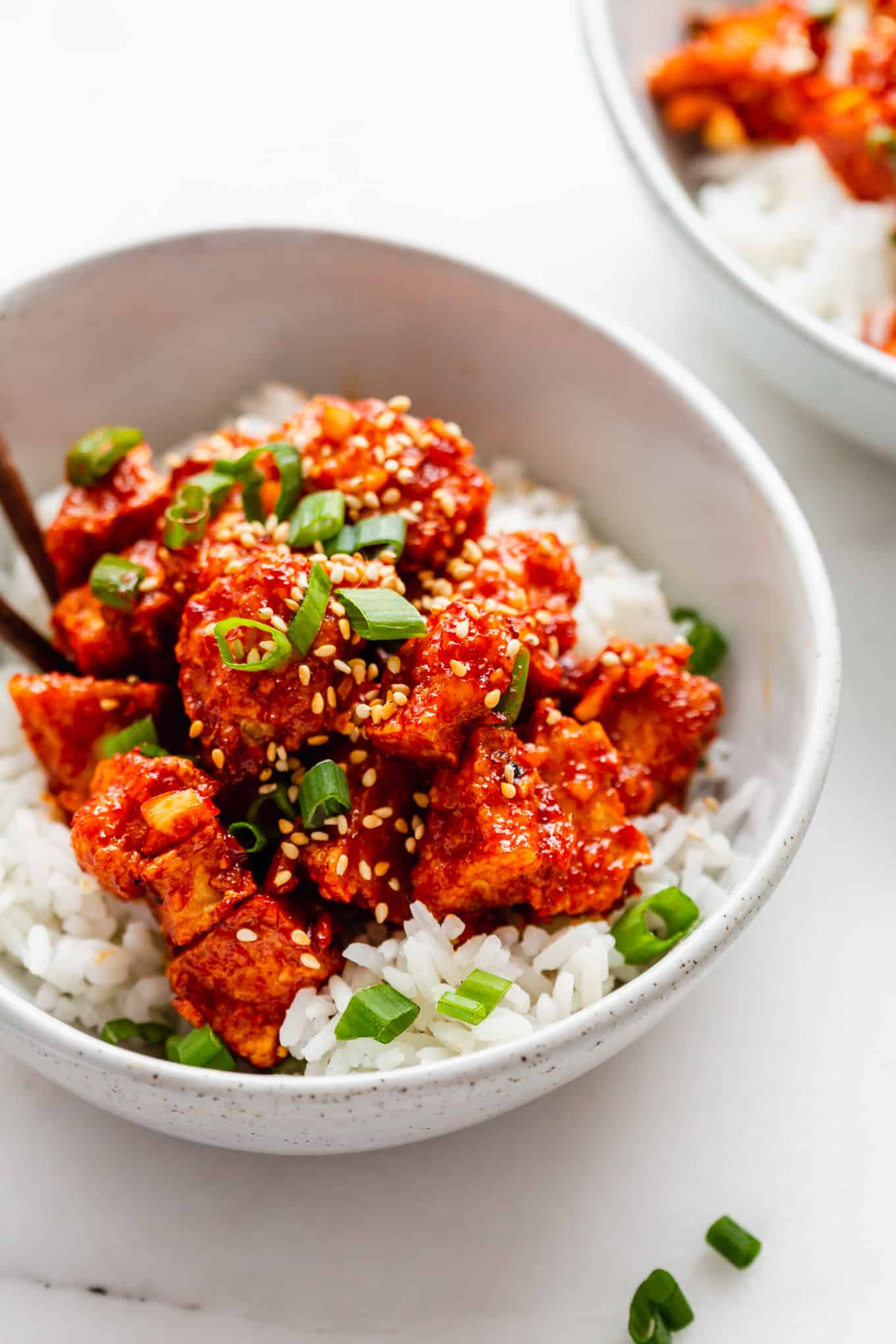 A bowl of gochujang Tofu topped with scallions