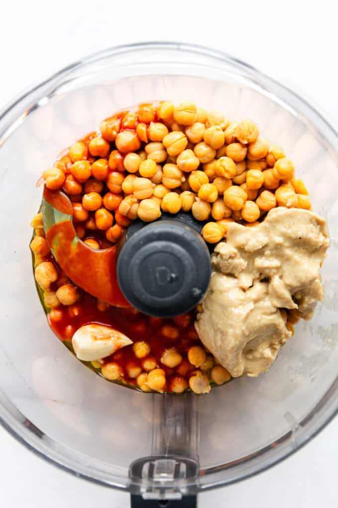 chickpeas, frank's red hot sauce, tahini, and garlic in a food processor