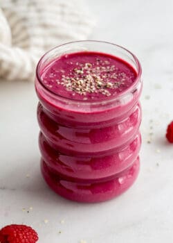a glass of beet smoothie with a napkin in the background