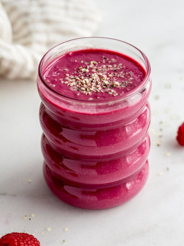 a glass of beet smoothie with a napkin in the background
