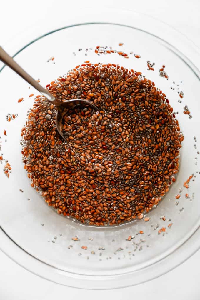 flax and chia seeds with water in a mixing bowl
