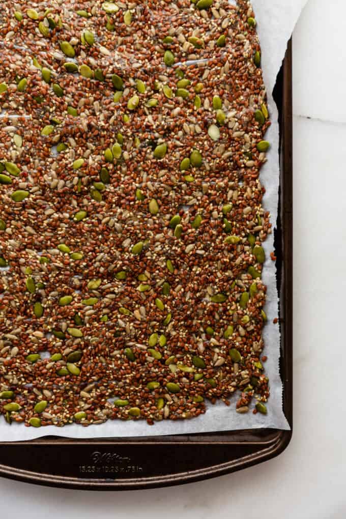 unbaked flax crackers on a baking sheet