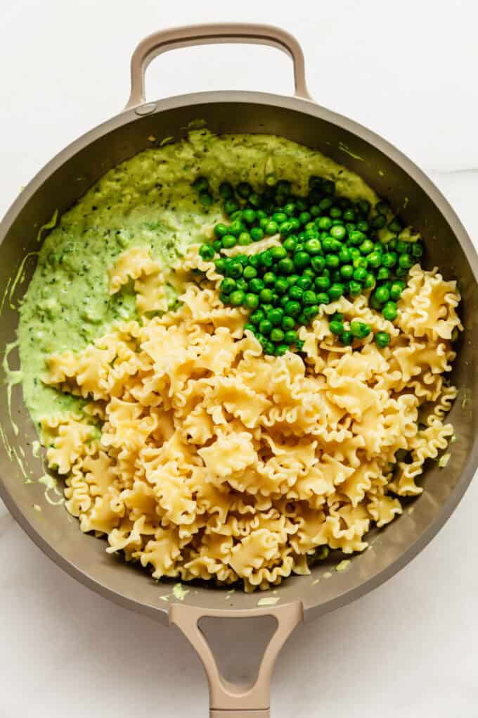 ricotta sauce, peas and pasta in a pan