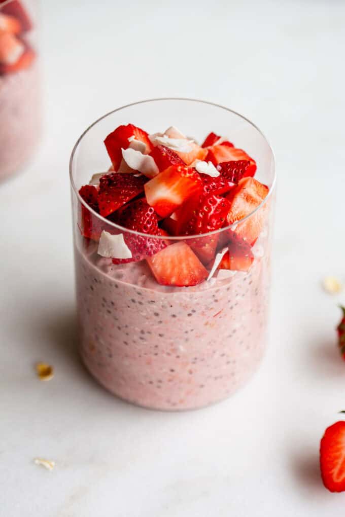 a jar of strawberry overnight oats topped with chopped strawberries