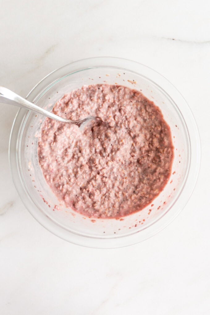 strawberry overnight oats in a clear mixing bowl